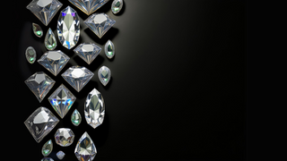 Réia Diamonds' exquisite lab-grown diamonds in various shapes, shimmering against a dark background, showcasing brilliance and clarity.