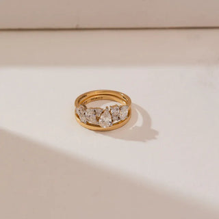 yellow gold stackable lab grown diamond engagement ring placed with a beige background