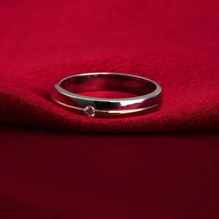 white gold men's lab grown diamond engagement ring placed on a red cloth