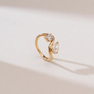 yellow gold lab grown diamond engagement ring placed with a beige background