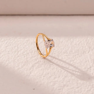 yellow gold lab grown diamond engagement ring placed with an off-white background