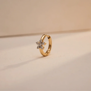 yellow gold lab grown diamond nose pin placed with a beige background