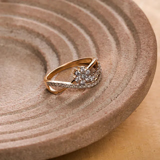 yellow gold lab grown diamond designer ring placed on a brown colored surface with a cream colored background
