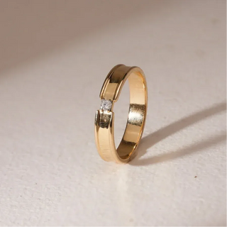 yellow gold lab grown diamond engagement ring placed with an off-white background