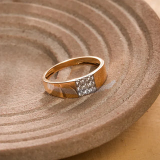 yellow gold men's lab grown diamond engagement ring placed on a brown colored surface