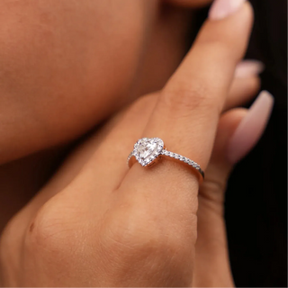 a woman wearing a white gold lab-grown diamond cocktail ring on her index finger