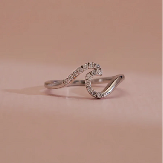 white gold lab grown diamond designer ring placed with a light cream background
