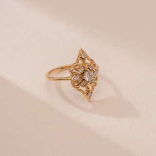 yellow gold lab grown diamond traditional ring placed on a cream colored surface