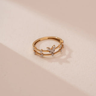 yellow gold lab grown diamond ring placed on a light cream colored surface 