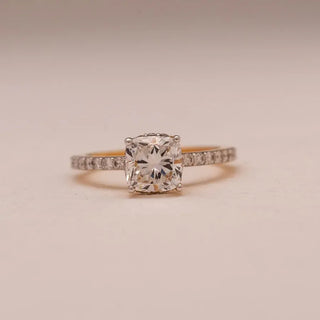 yellow gold solitaire lab grown diamond engagement ring placed with a cream colored background