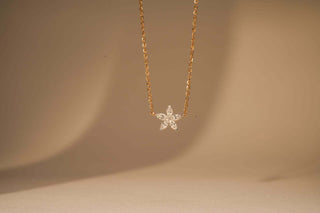 Front view of a hanging lab-grown diamond pendant on a beige background, crafted by Réia Diamonds.
