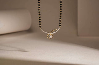 A gold ring with a row of three prominent diamonds is standing upright on a round, light-colored wooden platform. The surface has visible wood grain patterns, and the lighting creates a warm, natural ambiance with soft shadows.