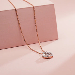 lab-grown diamond pendant placed on a light pink cardboard with a light pink background  