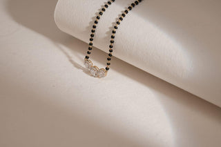 lab-grown diamond mangalsutra placed on a beige sheet with a beige background