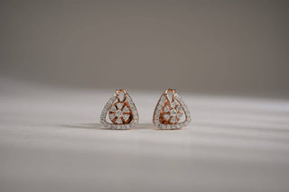 lab-grown diamond earrings placed in the center of the frame with a grey and white background