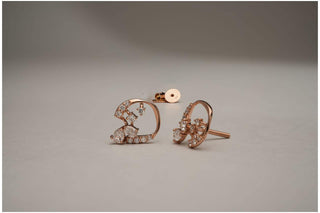 Rose gold open heart stud earrings with cluster-set lab-grown diamonds are displayed on a light gray surface with both earring backs visible.