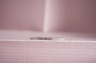 lab-grown diamond ring kept on a light pink background with a light pink background