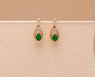 lab-grown diamond earrings placed on a cream cardboard with a light beige background