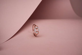 lab-grown diamond ring placed standing against a pink cardboard with a light pink background 
