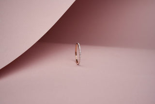 lab-grown diamond everyday band placed with a light pink background