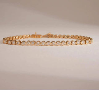 yellow gold lab-grown diamond bracelet placed with a beige background