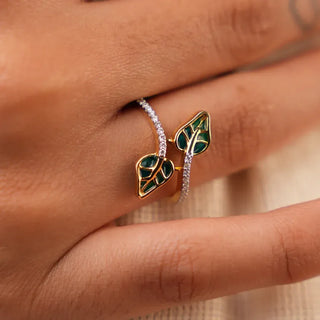 a woman's hand placed on a cream colored surface with a lab grown diamond traditional ring on her ring finger