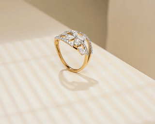 yellow gold lab grown diamond designer ring placed on a beige surface with a beige background