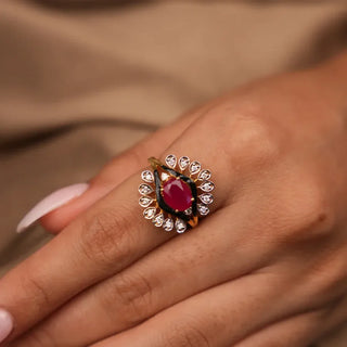 a woman's hand placed on a beige background with a lab grown traditional diamond ring on her index finger