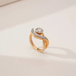 yellow gold lab grown diamond engagement ring placed with an off-white background
