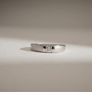 white gold men's lab grown diamond engagement ring placed with a white and grey background