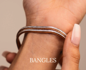 Hand wearing two sleek diamond-studded bangles by Réia Diamonds, showcased against a neutral background with the word 'BANGLES' displayed