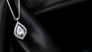 Front view of a lab-grown diamond pendant on a black background, crafted by Réia Diamonds.