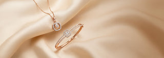 A Réia jewelry set featuring a rose gold necklace with a square diamond halo pendant and a rose gold bracelet with a rectangular center cluster and diamond accents.