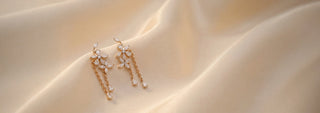 Side view of floral lab-grown diamond drop earrings in 14 KT yellow gold, featuring marquise-cut diamond flower motifs with delicate chain tassels ending in round brilliant diamond drops.