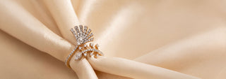 A Reia two-tone ring in yellow and white gold, featuring a large spiral shape set with many small lab-grown diamonds, on a white background.