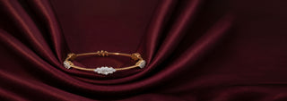 A Reia rose gold tennis bracelet featuring pear-shaped lab-grown diamonds, displayed on a pink surface.