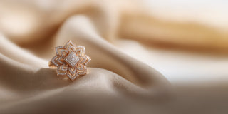 Réia rose gold flower-shaped ring with lab-grown diamonds, resting on satin fabric.