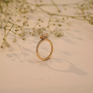 Side view of Reia's Celeste Embrace Solitaire Diamond Ring in 14KT yellow gold featuring a round-cut lab-grown diamond and pave-set shoulders.