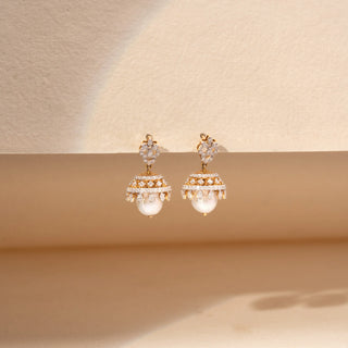 Front view of pearl and  pear shaped lab-grown diamond jhumka earrings in 14 KT yellow gold, featuring floral diamond studs, pavé-set dome motifs, marquise-cut diamond accents and lustrous pearl drops in a traditional design.