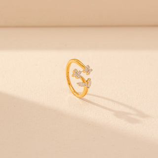 Angled view of Floral Vine Diamond Ring in 14KT Yellow Gold, featuring diamond flowers and leaf motifs along the open, flowing band.