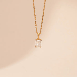 Close-up view of Emerald Cut Diamond Necklace in 14KT Yellow Gold, featuring a rectangular lab-grown diamond on a delicate chain.