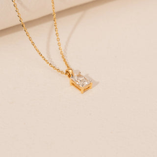 Angled view of Emerald Cut Diamond Necklace in 14KT Yellow Gold, featuring a rectangular lab-grown diamond in a prong setting.