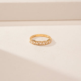 Close-up view of a 14KT Yellow Gold diamond band with alternating rectangular and round diamonds in a criss-cross pattern.