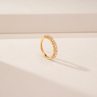 Angled view of a 14KT Yellow Gold diamond band with alternating rectangular and round diamonds in a criss-cross pattern.