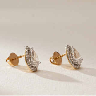 Side view of oval-cut lab-grown diamond halo stud earrings in 18KT Yellow Gold, showcasing a raised center stone encircled by a halo of diamonds with Bombay screw backs.