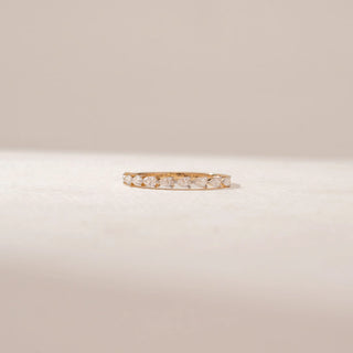 Front view of a 14KT Yellow Gold diamond band featuring alternating pear diamonds in a delicate half-eternity design.