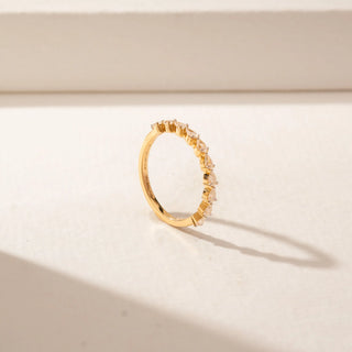 Angled view of a 14KT Yellow Gold diamond band featuring alternating pear diamonds in a delicate half-eternity design.
