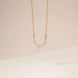 Front view of a diamond necklace in 14KT Yellow Gold, featuring a marquise floral pendant and diamond accents against a beige backdrop.