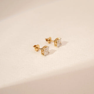 Side view of square-cut diamond stud earrings in 14KT Yellow Gold, featuring four-prong settings.