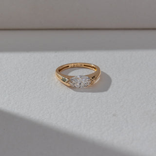 Top view of Marquise Solitaire Diamond Ring in 14KT Yellow Gold, featuring a centred marquise-cut lab grown diamond in prong setting. Set on a beige backdrop, the design highlights symmetry and refined brilliance.
